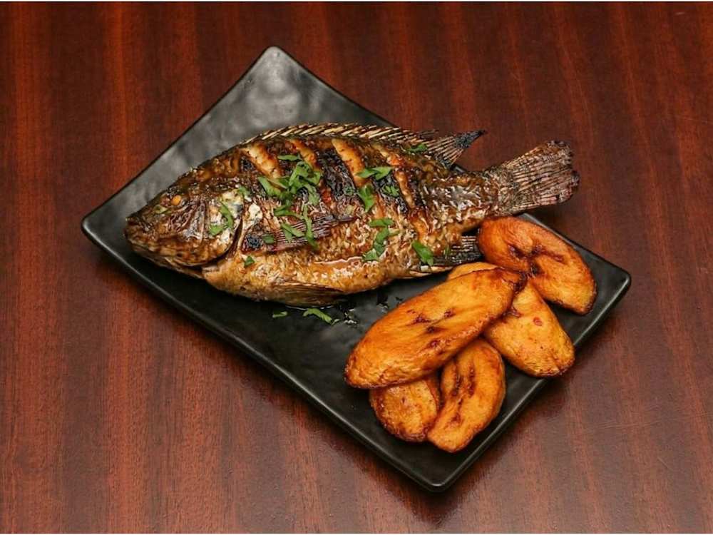 Grilled whole tilapia with fried plantain