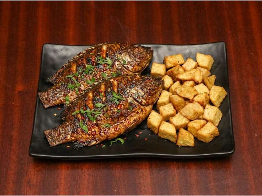 Grilled tilapia with fried yam cubes